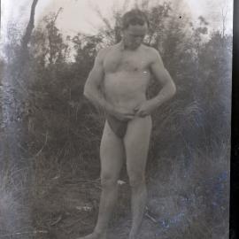 Bodybuilder adjusting his posing trunks, [n.d.]
