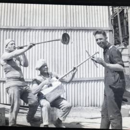 Three men clowning around with makeshift musical instruments, [n.d.]